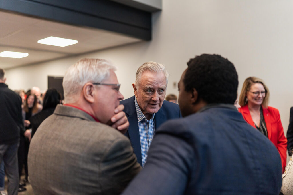 Former U.S. Senator Larry Pressler speaking with Marc-Antoine Niamba and Jack Marsh, co-founder of South Dakota News Watch, at the USD Discovery District Grand Opening.