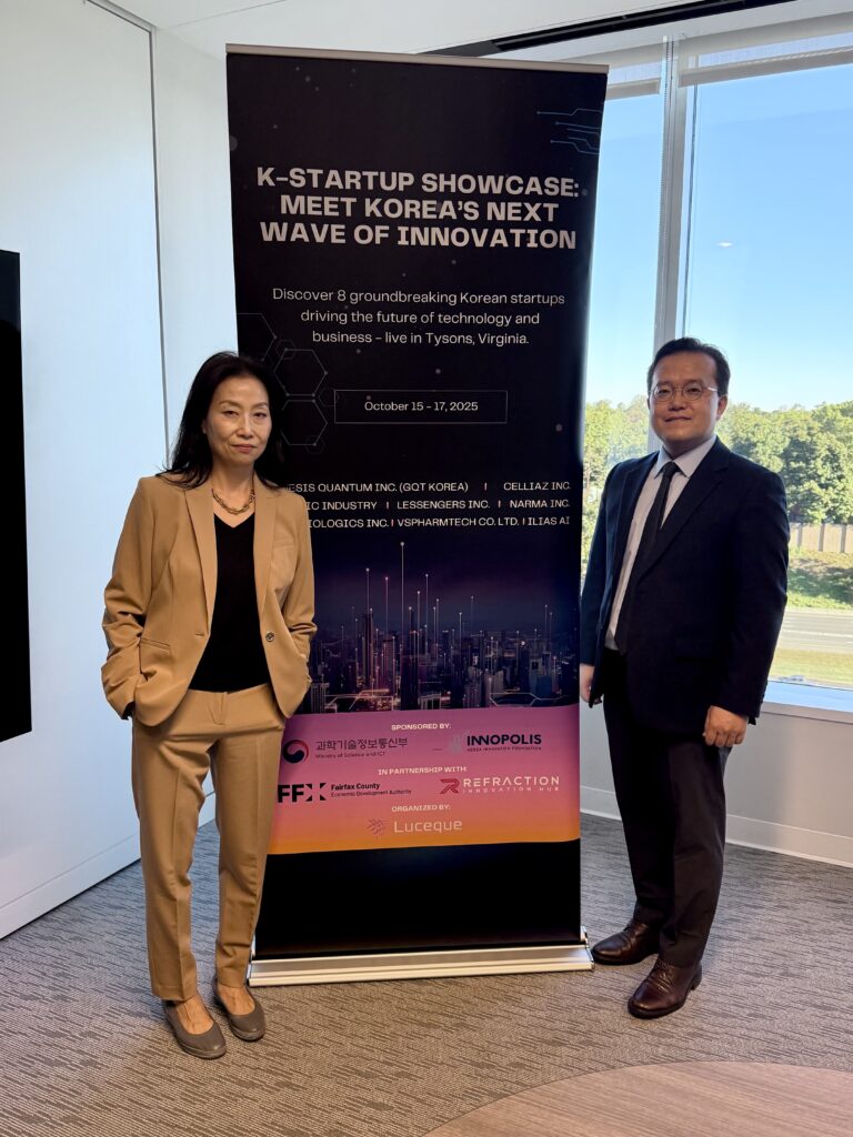 Julie Koo of Luceque Global and David Hwang, President of Luceque Korea, stand in front of the K-Startup Showcase banner in a conference room.