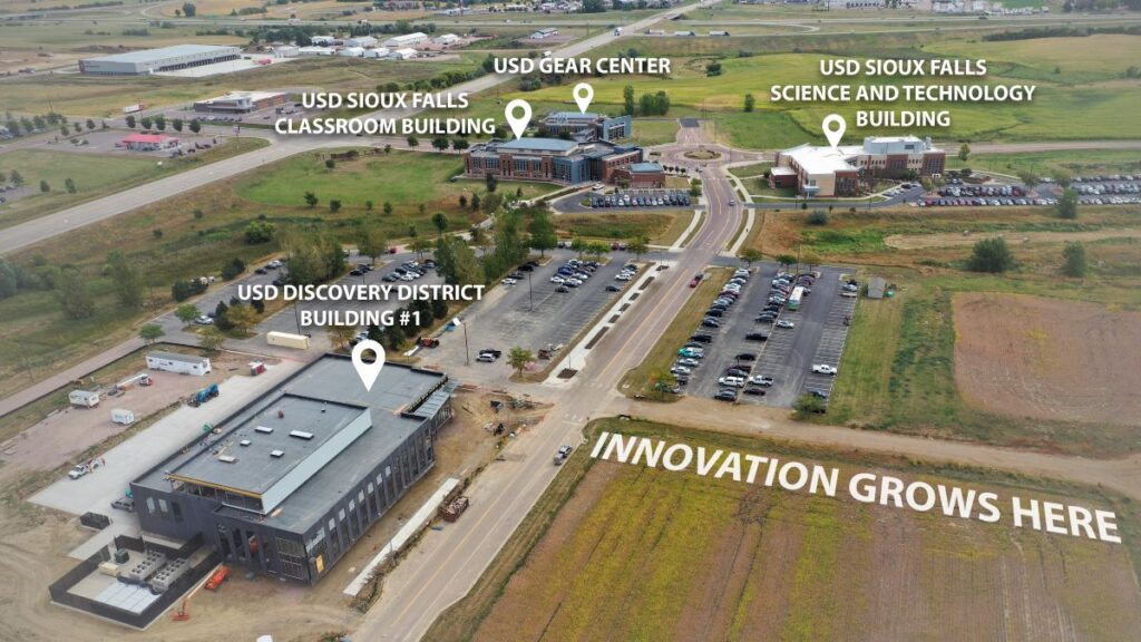 Aerial view of the USD Discovery District and neighboring USD Sioux Falls campus, showcasing Building 1 and the emerging innovation corridor.