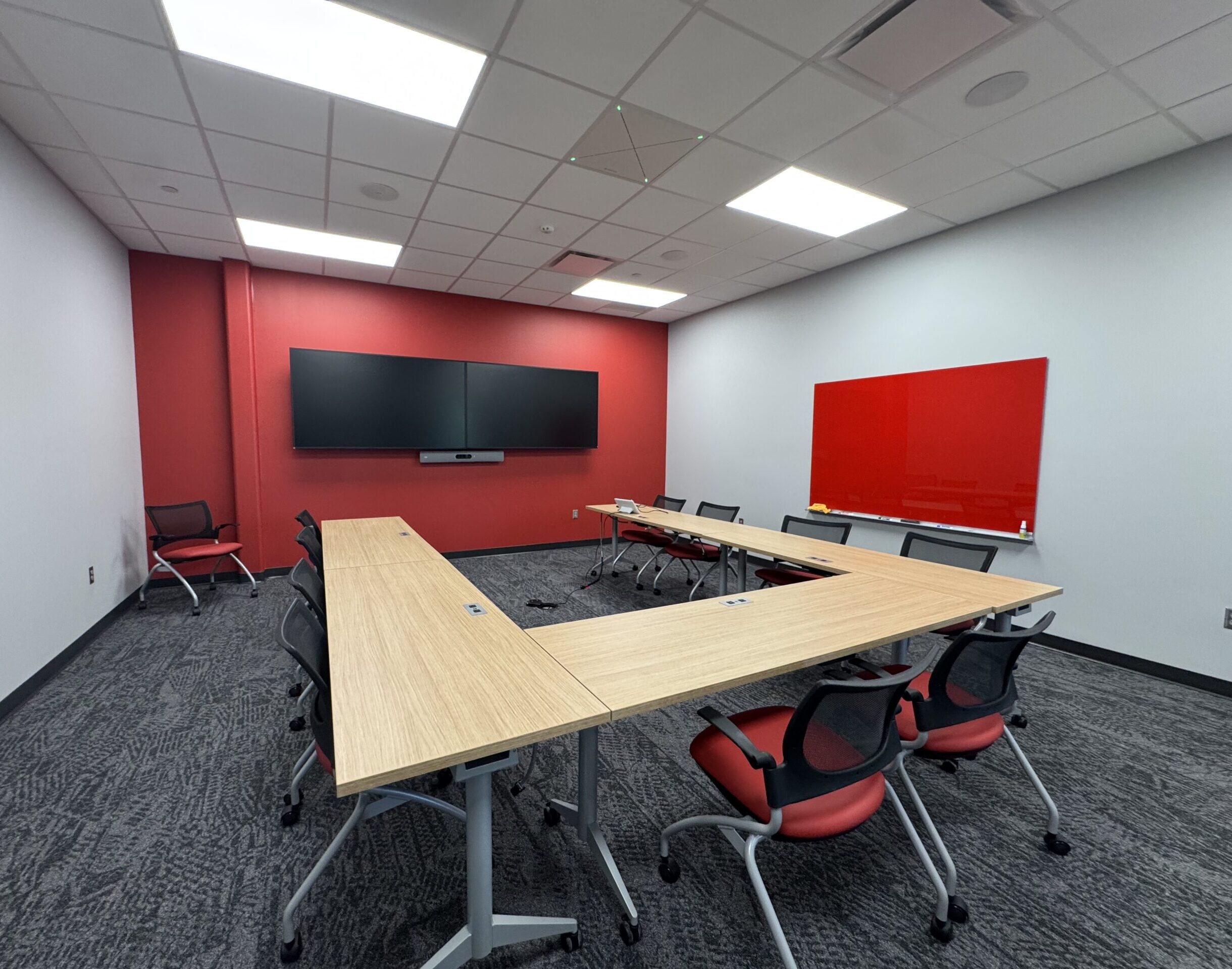 The second floor conference room in Building 1 features a marker board and monitors, ideal for team meetings and training.